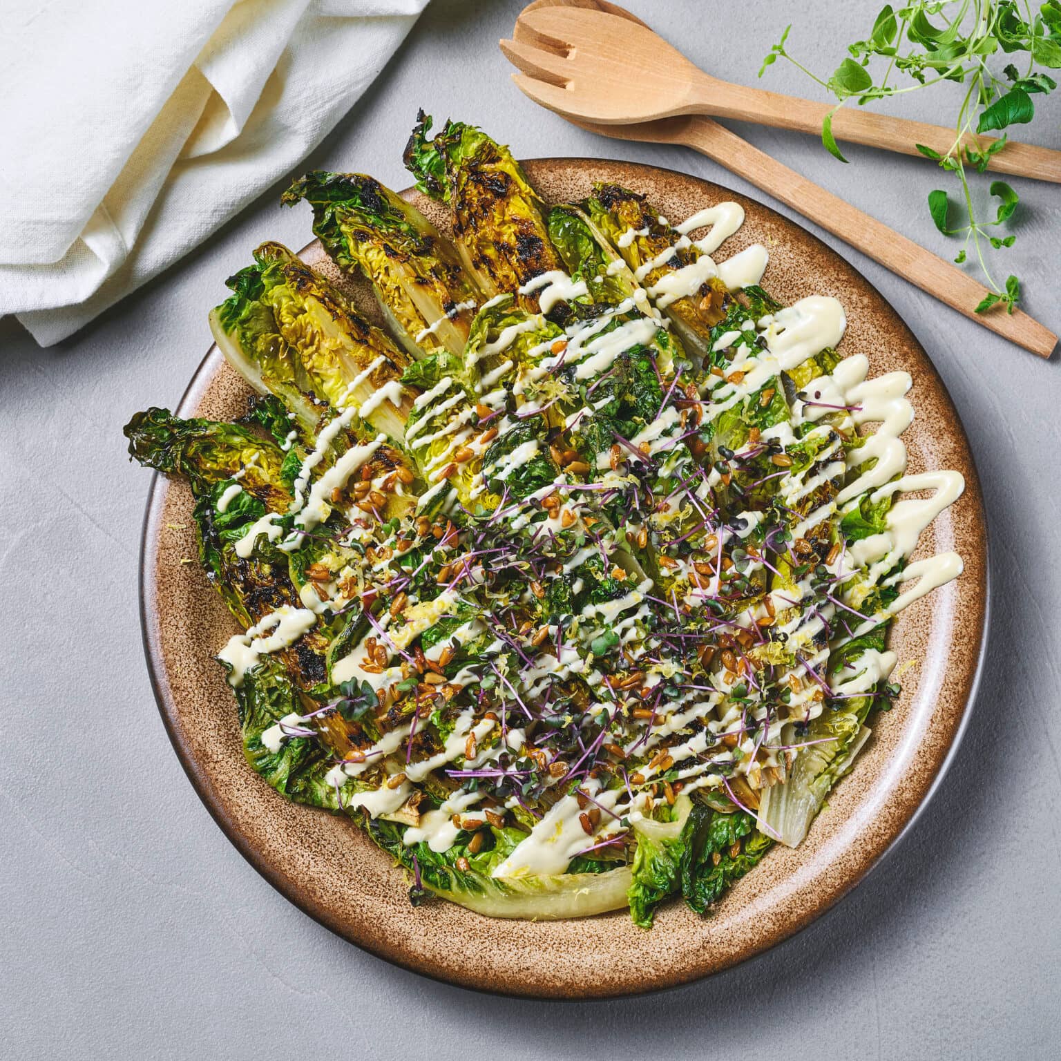 Grillet hjertebladsalat toppet med ristede solsikkekjerner og aioli